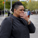 A woman cries as demonstrators throw rocks at Baltimore police.